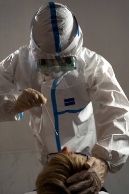 Medical personnel performing an antigen test for covid-19.