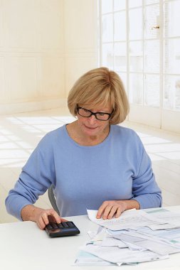Senior woman doing paperwork.