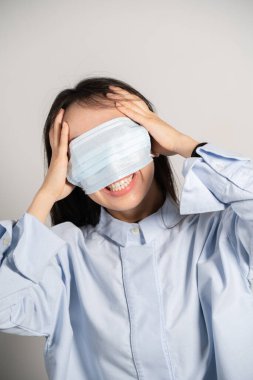 Young woman wearing a mask over her eyes