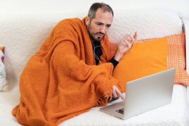 A sick man looking for a GP for a video consultation.