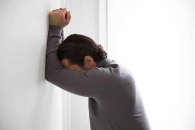 Depressed man on studio background