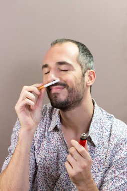 A man who is tempted to smoke again having given up smoking.