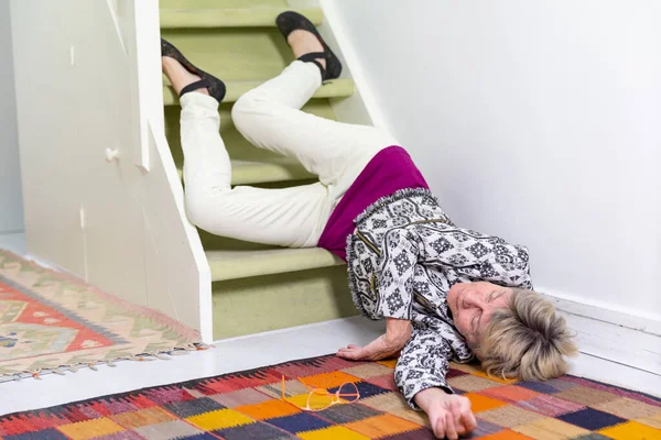 Elderly woman who has fallen down stairs.