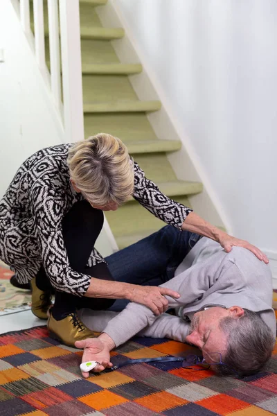 Elderly Woman Helping Elderly Man Who Has Fallen Stairs — Stockfoto
