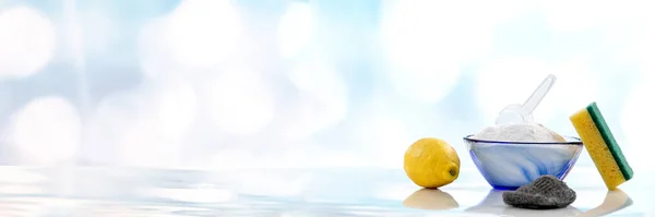 Household cleaning with baking soda, lemon and sponge isolated on white background.