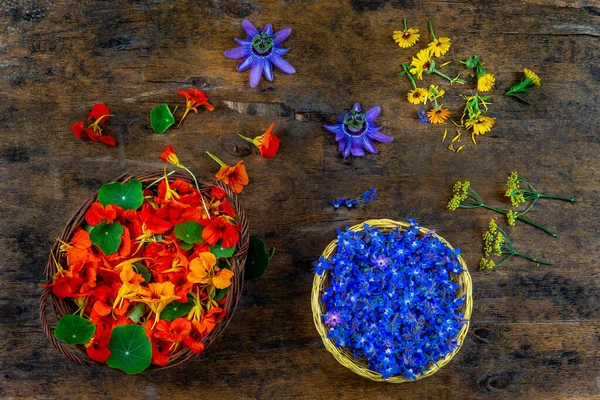 Baskets of edible flowers, nasturtiums and borage flowers used in gastronomy, view from above.