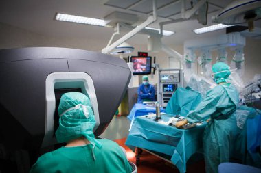 Robotic surgery in the operating room during a hysterectomy, the robot is driven by a surgeon from the console.
