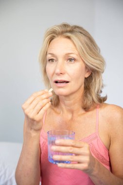 Woman taking medication. close-up