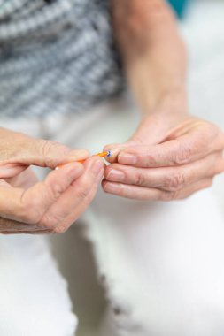 Cleaning a hearing aid.