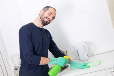 A man using cleaning products to clean.