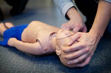 First aid training on an infant dummy.