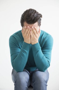 Depressed man on studio background