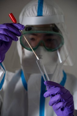 Man in protective suit during Covid-19 pandemic with PCR test