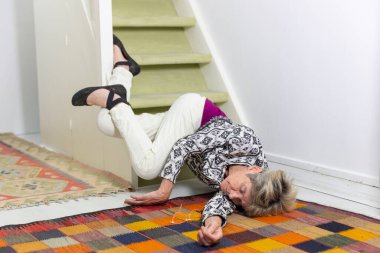 Elderly woman who has fallen down stairs.