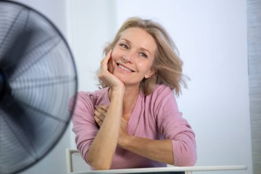 A menopausal woman having a hot flush.