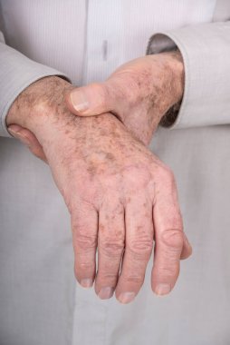 Senior man suffering from wrist pain.