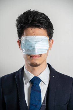 Man wearing a mask over his eyes