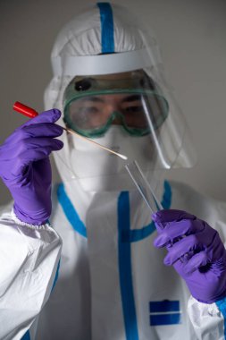 Man in protective suit during Covid-19 pandemic with PCR test