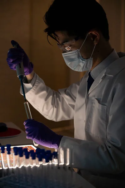 Male researcher in front of genome screens.