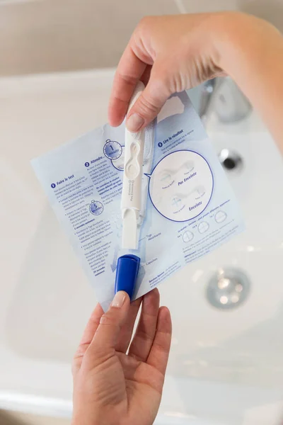 Woman Reading Instructions Pregnancy Test — Photo