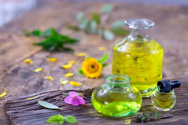 Alternative Medicine Essential Oils Bottle Potion Flowers Wooden Table — Stock Photo, Image