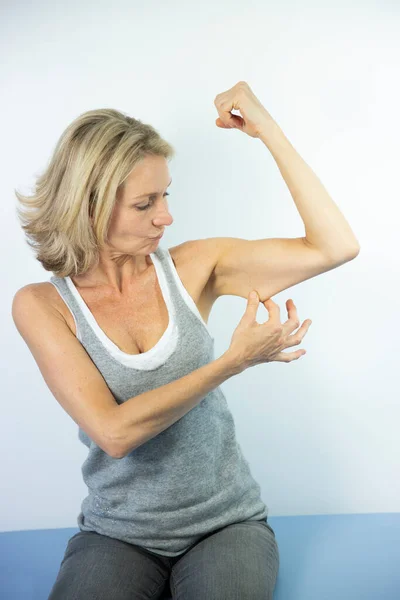 Woman Looking Her Muscles — Photo