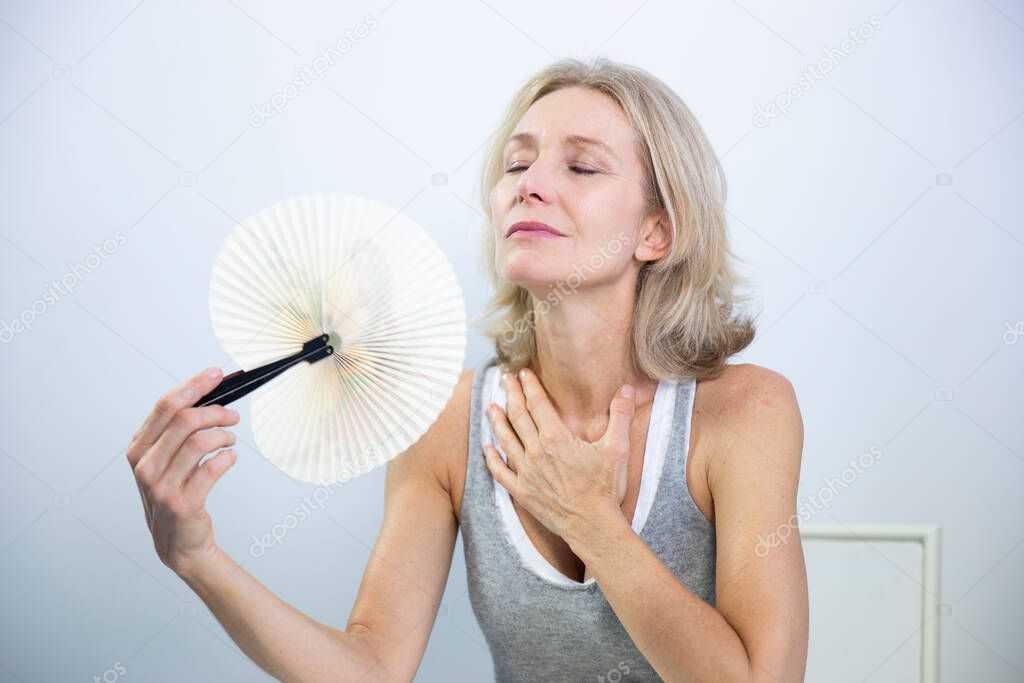 A menopausal woman having a hot flush.