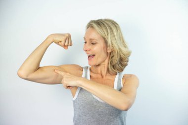 Woman looking at her muscles.