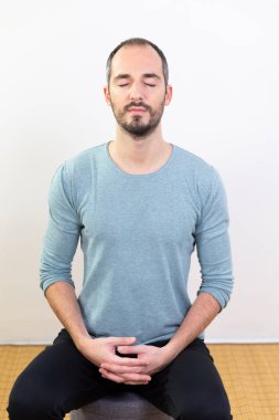 A man carrying out relaxation techniques.