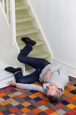 Elderly man who has fallen down stairs.