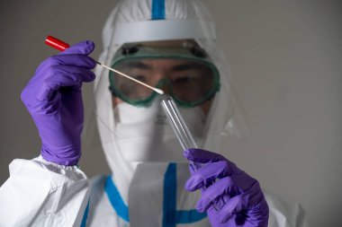 Man in protective suit during Covid-19 pandemic with PCR test