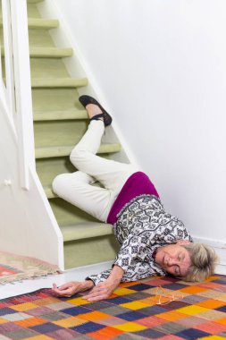 Elderly woman who has fallen down stairs.