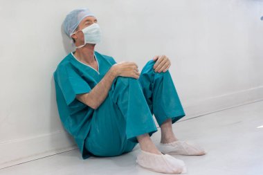A surgeon exhausted by his work.