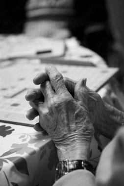 Elderly person crossing their fingers in a retirement home.