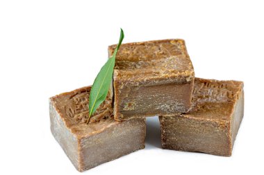 Close up of a trio of layered dalep soaps, isolated on a white background.