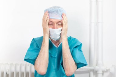 A surgeon exhausted by his work.