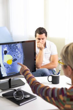 Man consulting a female doctor for prostate ultrasound examination.