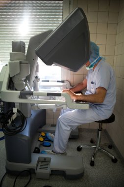 Surgeon performing prostatectomy using robot surgeon.