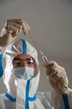 Medical personnel performing an antigen test for covid-19.