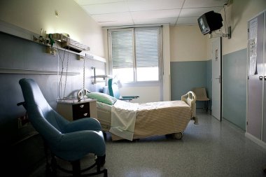 An empty private room in a hospital.