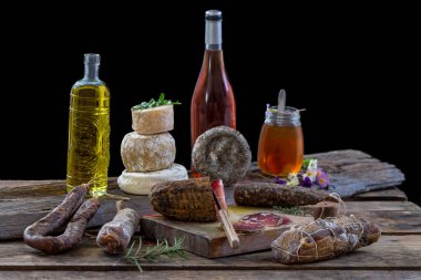 Several variety of traditional Corsican delicatessen on rustic background.