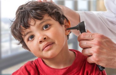 Doctor examining a child's ear.