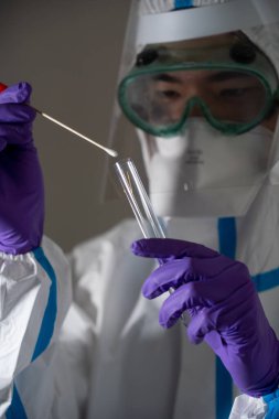 Man in protective suit during Covid-19 pandemic with PCR test