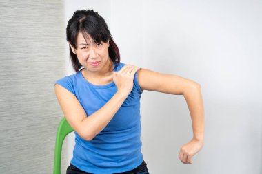 Asian woman having shoulder pain