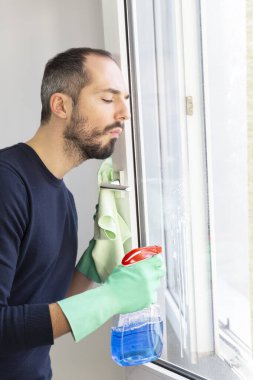 A man cleaning a window.