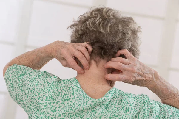 Senior Woman Scratching Herself — Zdjęcie stockowe