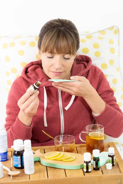 Young woman hesitating between industrial or natural medical treatments.