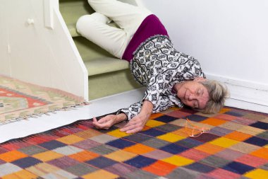 Elderly woman who has fallen down stairs.