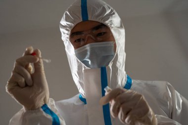 Medical personnel performing an antigen test for covid-19.