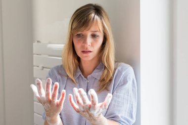 A woman suffering from contamination OCD: obsessive hand washing.